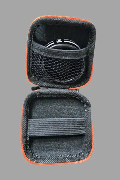Jax Wanderlust Mini Zip Case with Carabiner in Black and Orange by Maskulo. Compact accessory storage with clip for convenience.