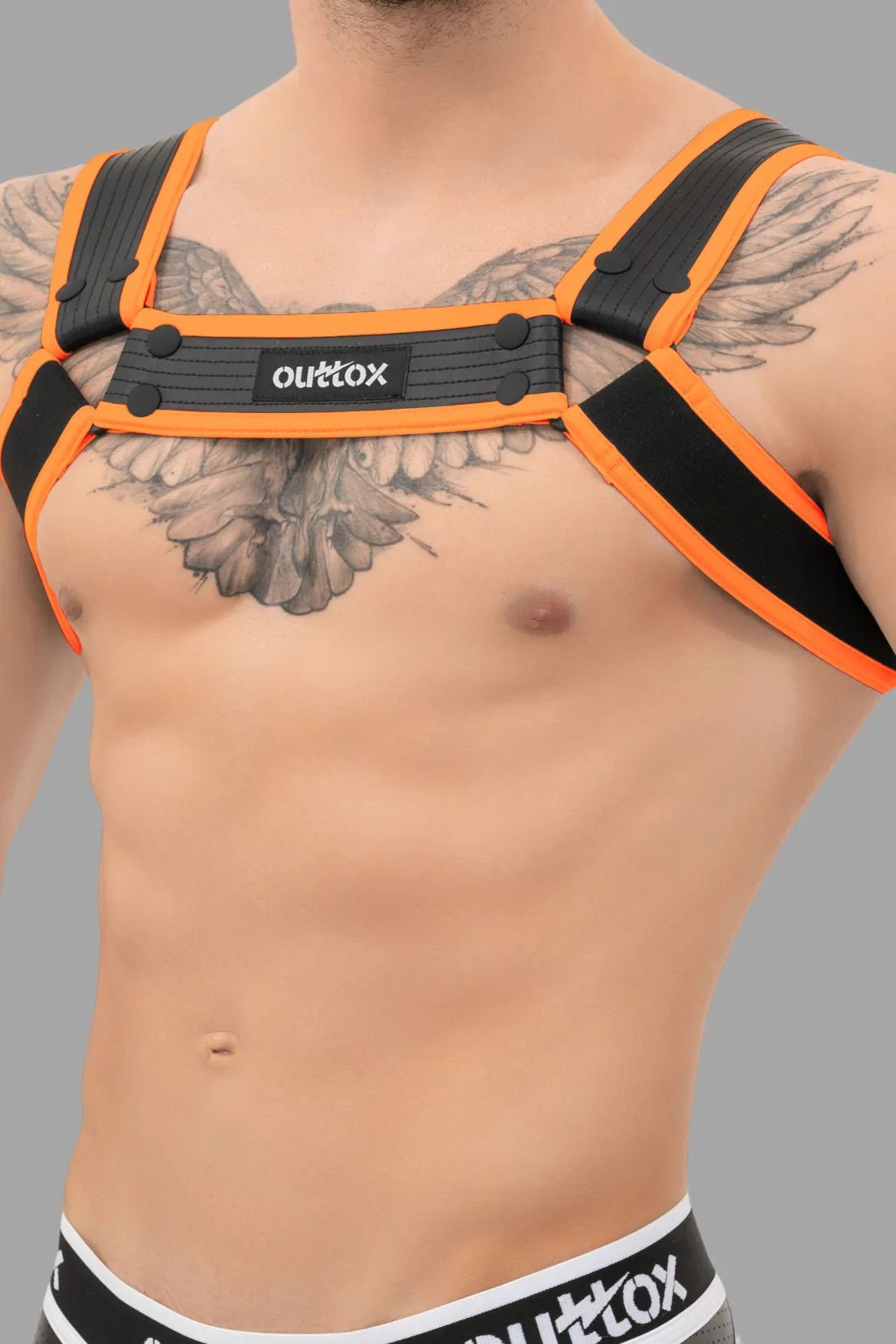 Outtox Bulldog Harness in Black/Orange by Maskulo. Polyester/PU leather straps, adjustable with snaps/buckles, for a bold, fetish look.