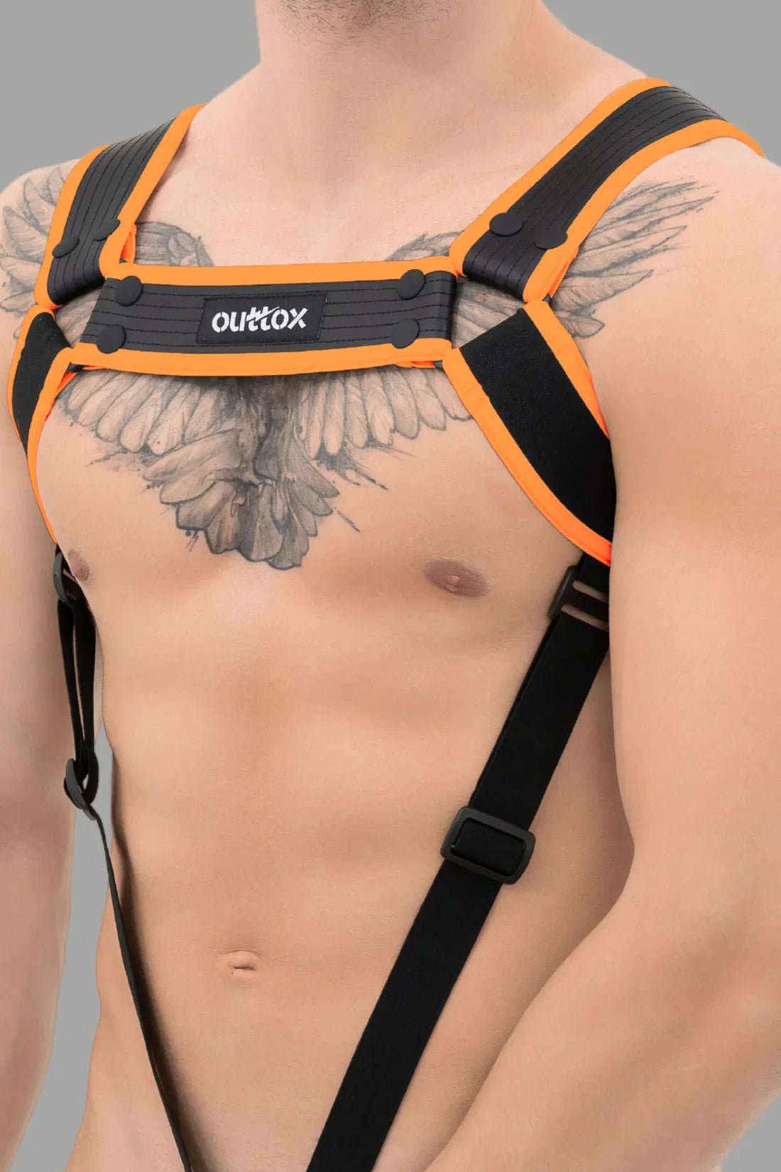 Outtox black and orange body harness with snaps for men, made from polyester/polyurethane/elastane blend. Comfortable adult costume accessory.