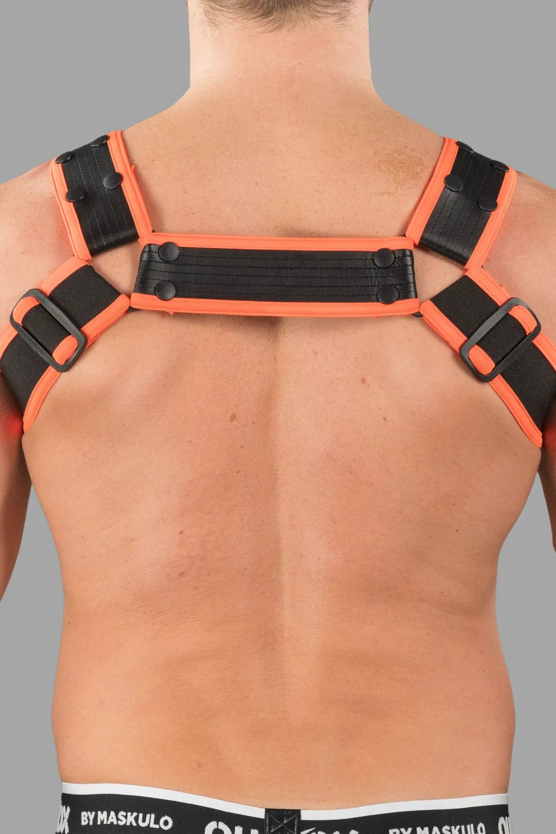Outtox by Maskulo Bulldog Harness with Snaps in Black and Orange. An edgy accessory for men, available at Maskulo Global (EU) online Store.