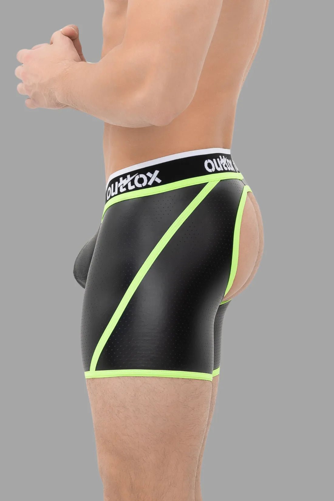 Outtox black and green open rear shorts with snap codpiece by Maskulo. Polyester/polyurethane/elastane blend, perforated faux leather.