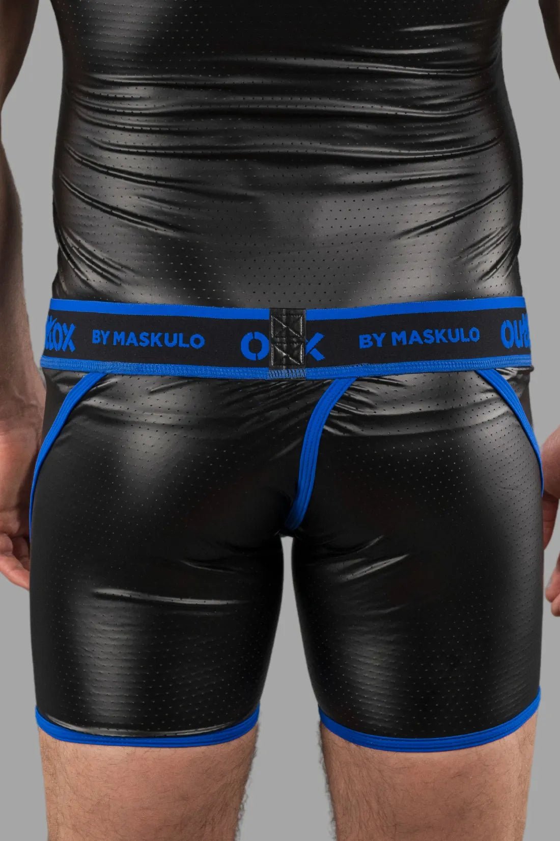 Outtox by Maskulo Wrapped Rear Shorts in black and blue with snap codpiece. Perforated PU eco leather, polyester blend. Shorts.